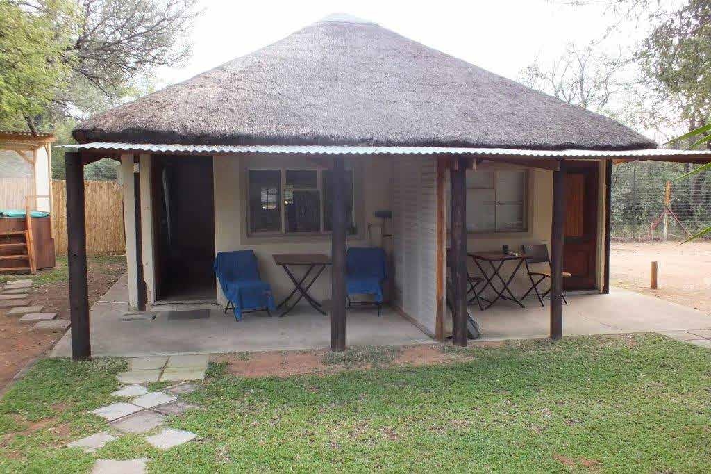 Thatched cabin exterior at Lauma Aurora (OUMA) naturist bush camp