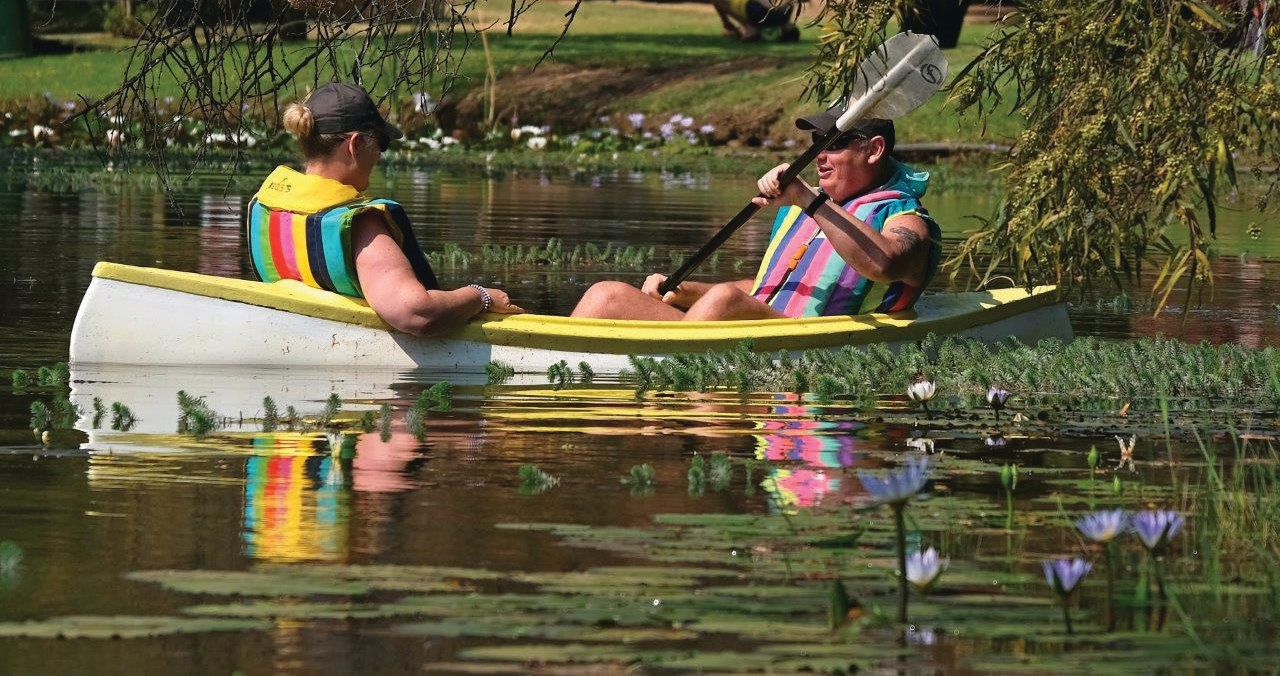 Canoeing on the dam at SunEden Naturist Resort